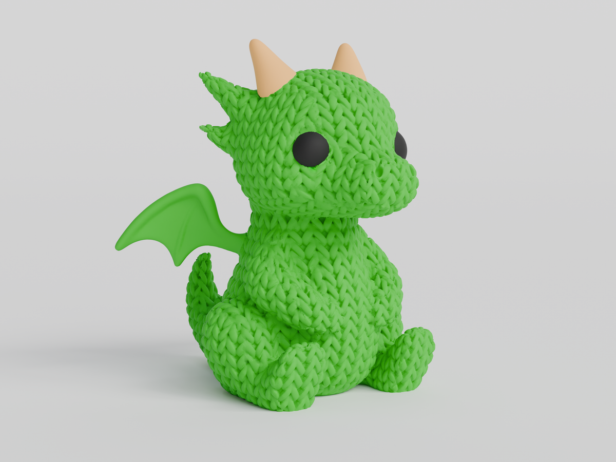Green knit-texture dragon figurine with cream-colored horns, black eyes, small wings, and a curled tail.